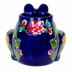 A glossy cobalt blue ceramic frog-shaped vessel with hand-painted floral motifs in red, green, yellow, and white, set against a plain white background.