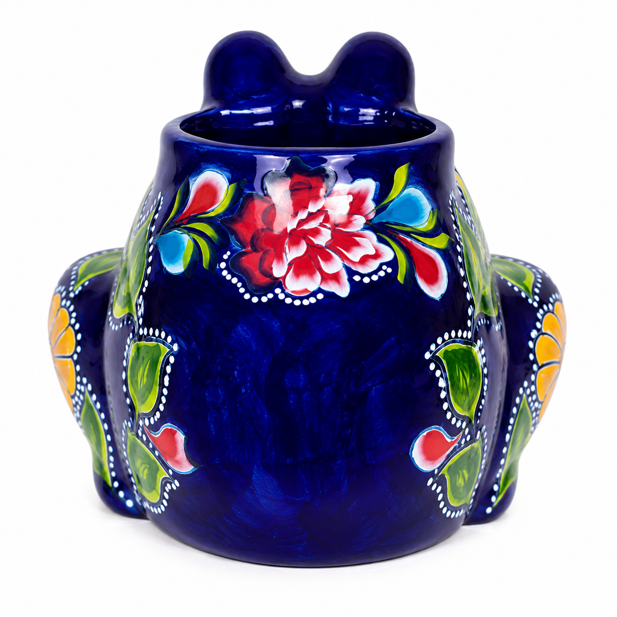 A glossy cobalt blue ceramic frog-shaped vessel with hand-painted floral motifs in red, green, yellow, and white, set against a plain white background.