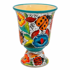 A hand-painted ceramic planter pot with a footed base, decorated with vibrant floral and ladybug motifs on a white background.