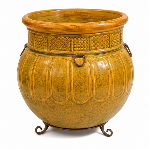 A large decorative ceramic cauldron-shaped planter in a textured mustard yellow and ochre glaze, featuring embossed vertical panels, a patterned band around the neck, and a dark metal stand with three legs and side rings, shown on a white background.
