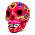A vibrant pink ceramic sugar skull decorated with colorful floral and geometric patterns, set against a plain white background.