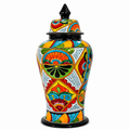 A hand-painted ceramic lidded jar with a vibrant, multicolor Mediterranean style pattern featuring red, orange, yellow, green, and blue motifs on a white background, set against a plain white studio backdrop.