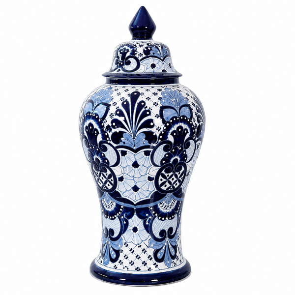 A blue and white patterned ceramic lidded jar with a pointed blue lid, featuring intricate floral and scroll motifs on a white background.